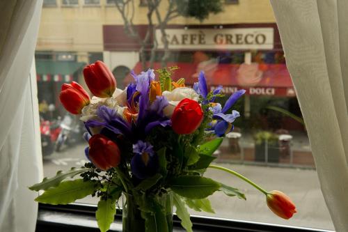 a vase filled with flowers on top of a window sill at Hotel Boheme in San Francisco