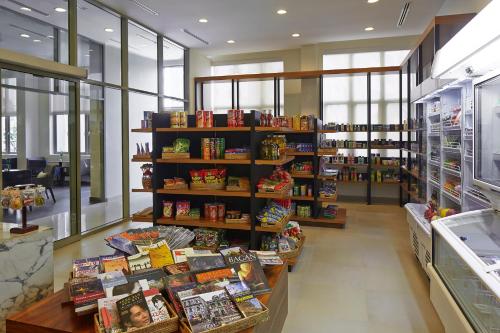 a store aisle with shelves of food and books at Shangri-La Serviced Apartments, Yangon in Yangon