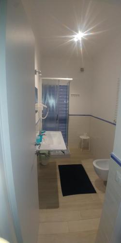 a bathroom with a sink and a toilet and a light at Zefiro in Fiumicino