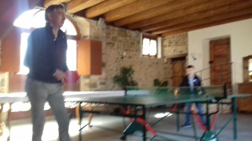 a man standing in front of a ping pong table at Alloggio Agrituristico Conte Ottelio in Pradamano