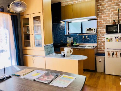 a kitchen with a table and a counter top at Midtown Sakura Apartment House 201 予約者だけの空間 A space just for you in Katsuura