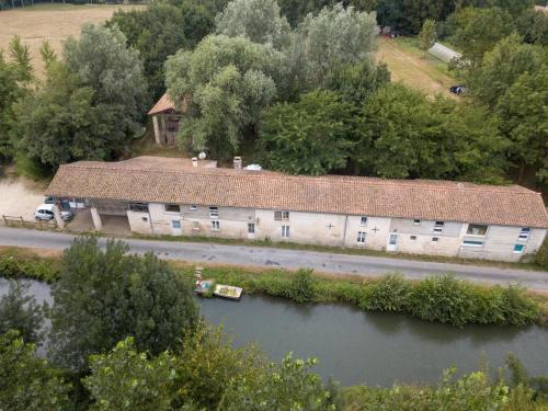 an aerial view of a building next to a river at Relais de la Venise verte in Coulon