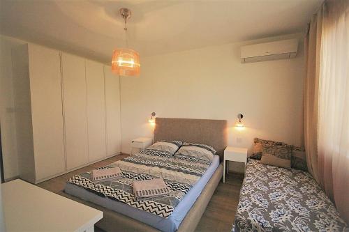a small bedroom with a bed and a couch at St. Seraphim's Apartment in Sofia