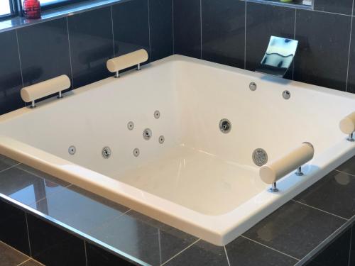 a large white bath tub in a bathroom at The Glen in Raleigh