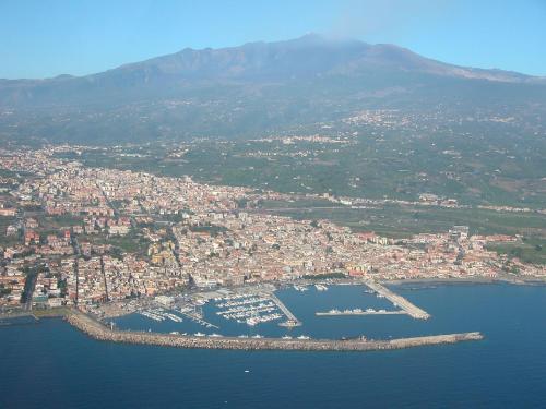 an aerial view of a city with boats in the water at Suite Cavour - SunTripSicily in Riposto