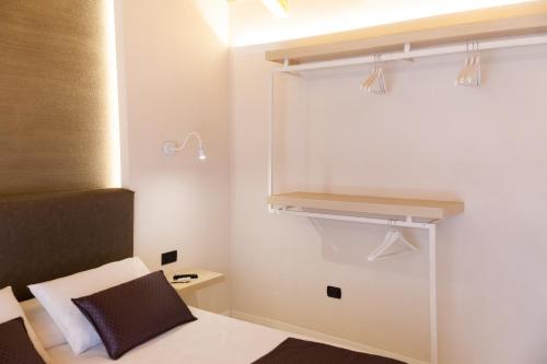 a small bedroom with a bed and a closet at Suite Cavour - SunTripSicily in Riposto