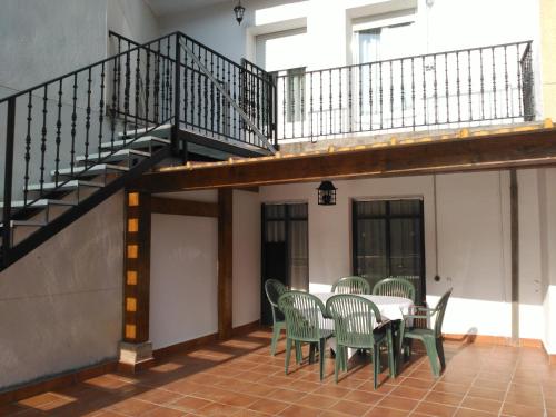 a patio with a table and chairs and a staircase at APARTAMENTOS LA CASONA DE EZCARAY CON TERRAZAS y PATIOS INDIVIDUALES in Ezcaray