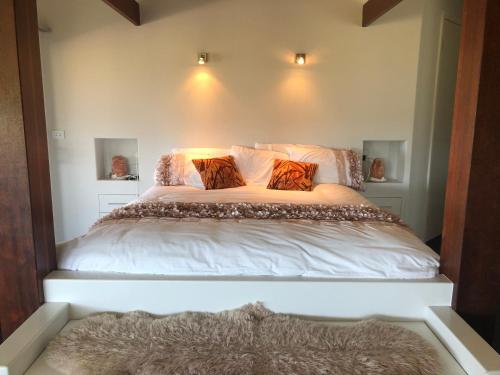 a bedroom with a bed with white sheets and pillows at The Glen in Raleigh
