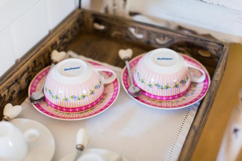 two plates and bowls are sitting on a table at Oleander Romantik Zimmer in Trausdorf