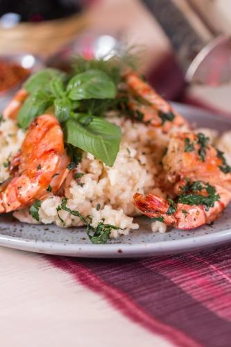 a plate of shrimp and rice on a table at Party Hotel Taverne in Obertauern