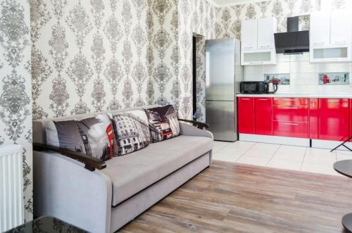 a living room with a couch and a kitchen at Admiral in Kharkiv