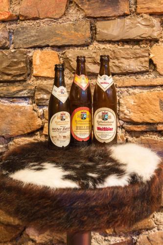 a group of four beer bottles on a wall at Party Hotel Taverne in Obertauern