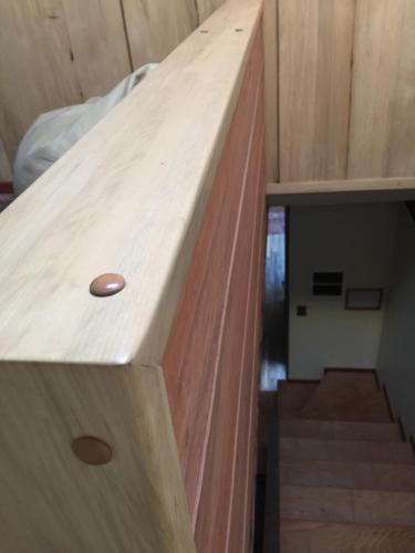 a wooden counter top in a room with stairs at DreamWoods in Puerto Varas