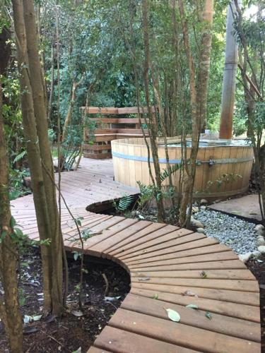 a wooden boardwalk in the middle of a garden at DreamWoods in Puerto Varas