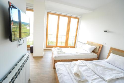 Postel nebo postele na pokoji v ubytování Papa Apartments
