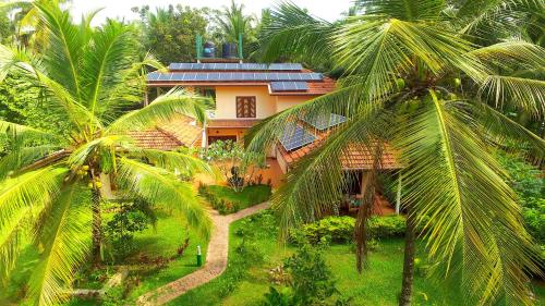 an aerial view of a house with palm trees at King Coconut Lodge in Habaraduwa Central