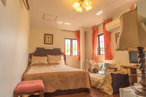 a bedroom with a bed and a chair and windows at Nikko Park Lodge Mountain Side in Nikko