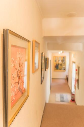 a hallway with paintings on the walls at Nikko Park Lodge Mountain Side in Nikko