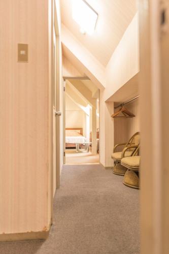 a hallway of a room with a bed in the distance at Nikko Park Lodge Mountain Side in Nikko