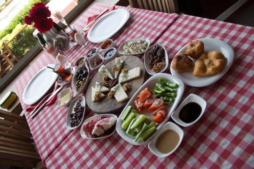 a picnic table with food on a red and white checked table cloth at Aliye Hanim Hotel in Ayvalık