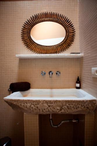 a bathroom with a sink and a mirror at Casa Rural Refugio Marnes in Benissa