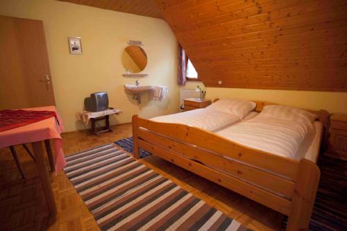 a bedroom with a large bed and a sink at Pension Elke Rothenburg in Rothenburg ob der Tauber