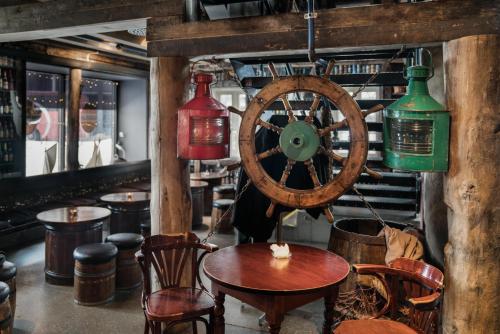 a room with a wooden wheel and a table and chairs at Radisson Blu Hotel Tromsø in Tromsø