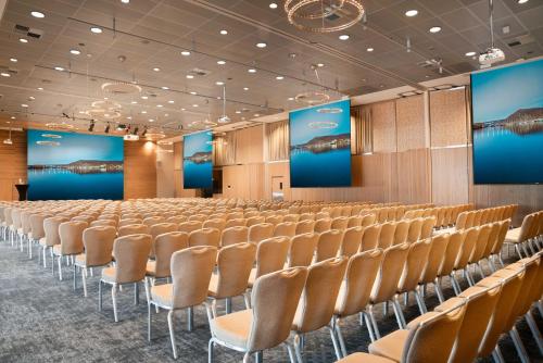 an empty conference room with chairs and screens at Radisson Blu Hotel Tromsø in Tromsø
