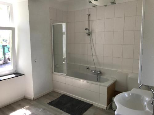 a bathroom with a shower and a tub and a sink at Ferme du Grand Frêne in Naomé