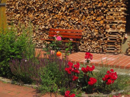 a bench in front of a pile of wood at Ferienwohnung Baier in Bad Griesbach