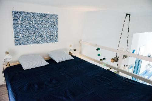 a bedroom with a bed with a blue blanket at Pause Apartment with Free Parking in Budapest