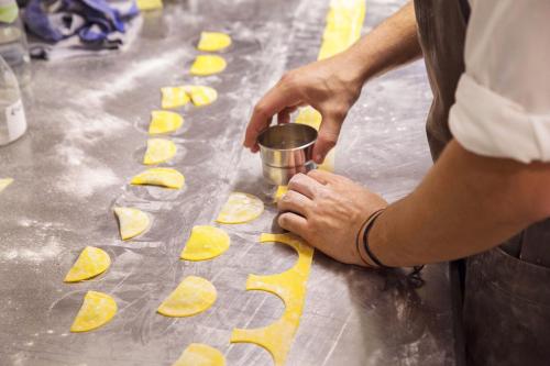 a man is preparing food on a table at Kircherhof in Bressanone