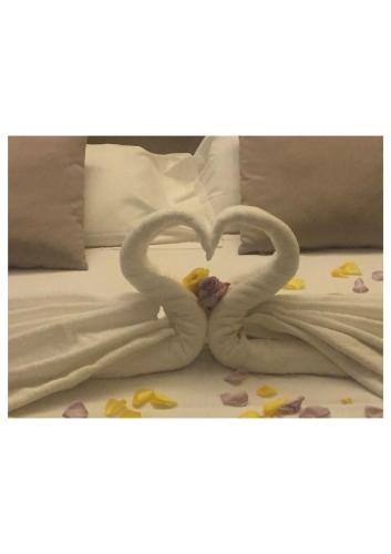 two swans making a heart on a bed at TH Assisi - Hotel Cenacolo in Assisi