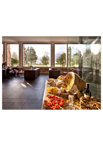 a lobby with a table with food on it at TH Assisi - Hotel Cenacolo in Assisi