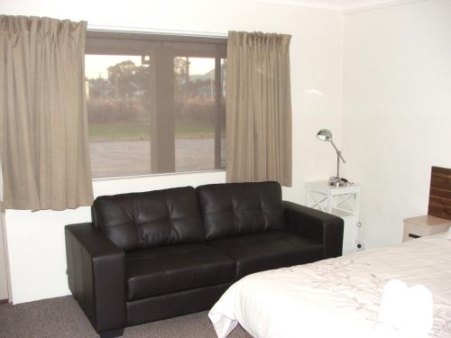 a living room with a couch and a coffee table at Murray Valley Motel in Wodonga