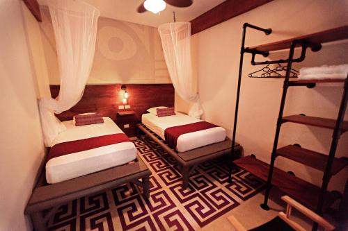 a hotel room with two beds and two lamps at Jungle Lodge Tikal Hostal in Tikal