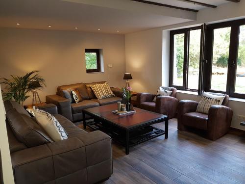 a living room with couches and a coffee table at Forester in Malmedy