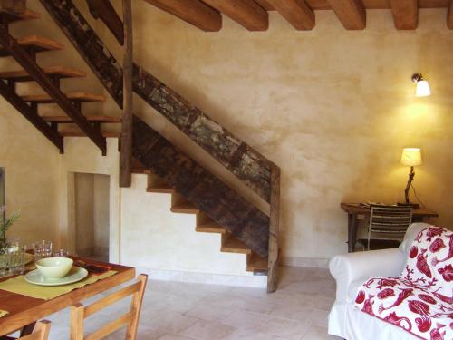 a living room with a staircase and a table at Oasi Galbusera Bianca in Rovagnate