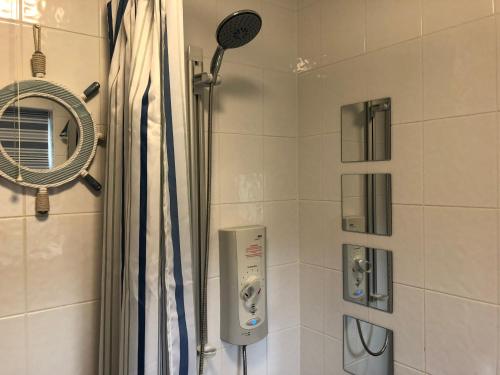 a bathroom with a shower and a mirror at 1 Silkin Serviced Accommodation in Newton Aycliffe