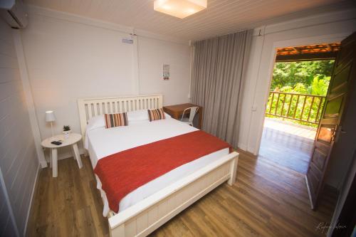 Una cama o camas en una habitación de Pousada Seu Dodó