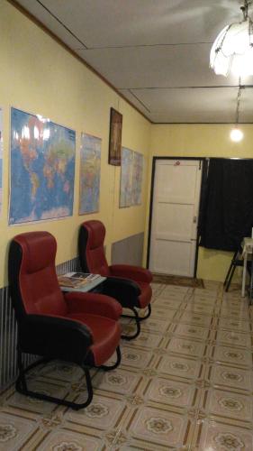 a waiting room with three chairs and a door at The Kong in Bangkok