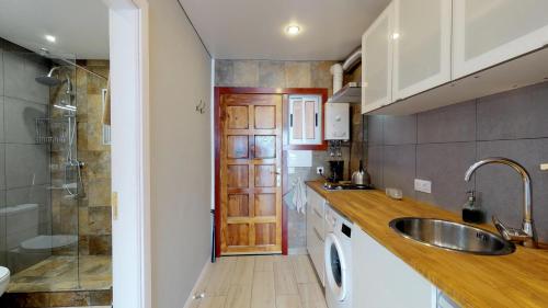 a kitchen with a sink and a shower at Cosy 0cean View Studio 1 in Icod de los Vinos