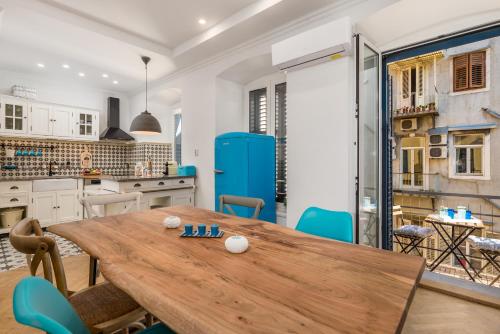 a kitchen and dining room with a wooden table and chairs at Luxury apartment Karolina Riva 101m2 in Rijeka