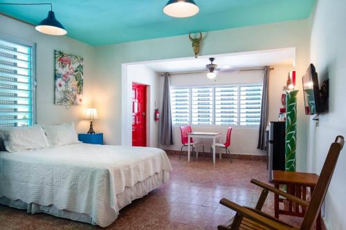 a bedroom with a bed and a table and chairs at La Esmeralda PR in San Juan