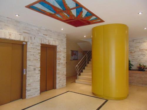 a lobby with a yellow column and a stained glass ceiling at Apartamentos varios con 2 dorm en Marina Dor , la playa de Amplaries 47 , vista lateral al mar in Oropesa del Mar