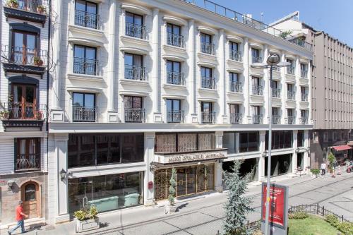 a large white building on the side of a street at Miss Istanbul Hotel in Istanbul