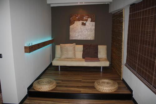 a living room with a couch and two baskets on the floor at Elements Hotel in Regensburg