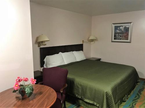 a hotel room with a bed and a table at Atlantic Motel in East Wareham