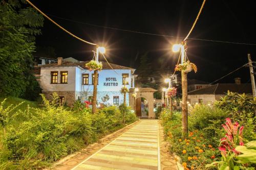 a walkway in front of a building at night at Hotel Kastro in Gjirokastër