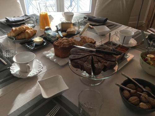 a table with a bunch of bread and pastries on it at Chambres d'Hotes au Pays de Valencay en Berry in Valençay
